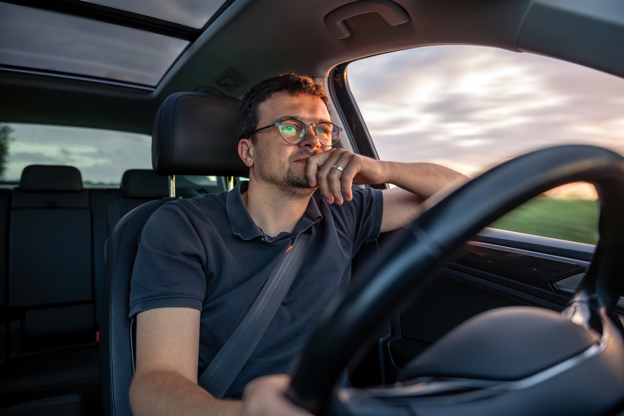Driver on highway at sunset