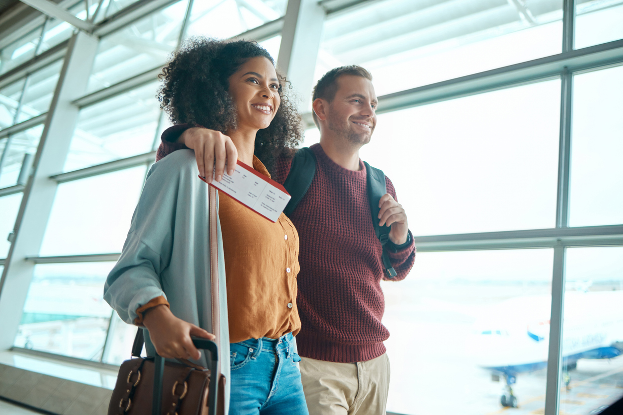 Couple arriving at the airport with luggage