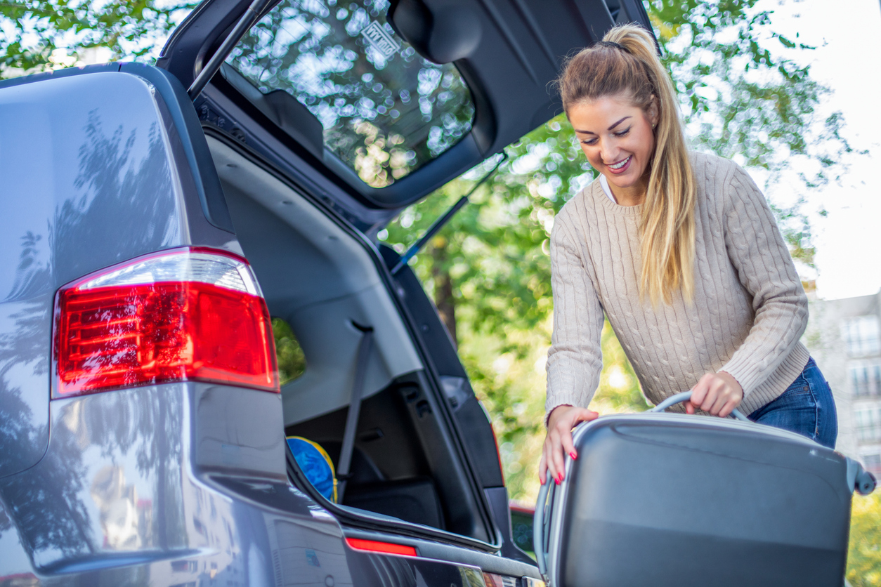 Woman loading luggage into her car before traveling from Airport